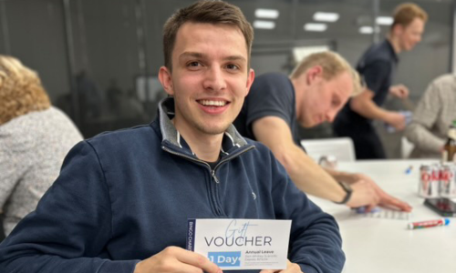 Young man holding a voucher at a bingo table