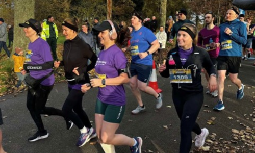 A Group of runners wearing running equipment and headphones during a half marathon