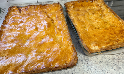 Large pies in baking trays