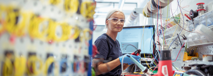 Production engineer wearing safety goggles