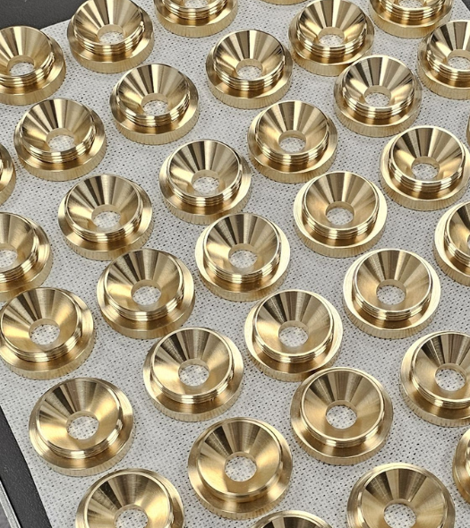 Manufactured machine parts laid out on a tray