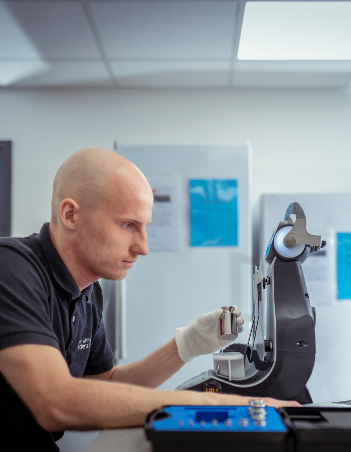 DWS Service Engineer, Joe Murray, performing calibration of non-automatic weighing machines.