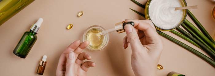 Hands with beauty products open on table